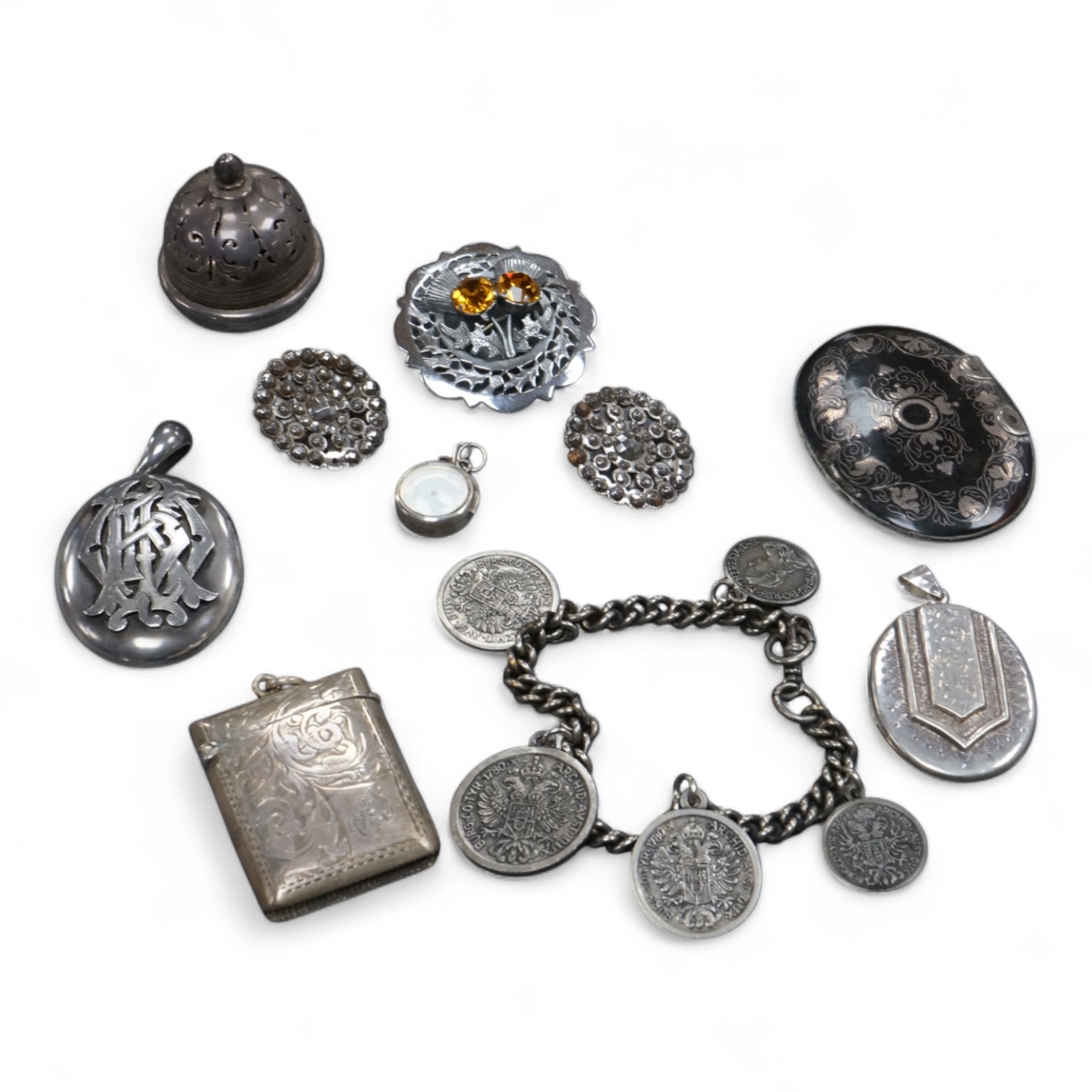 A mixed group of assorted collectables including a silver vesta case, two Victorian white metal lockets, two cut steel buttons, a coin bracelet and three other items.